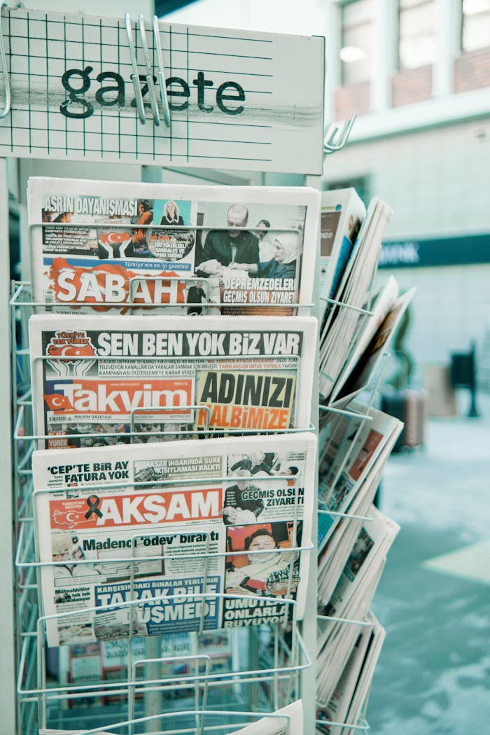 A rack with various Turkish newspapers displayed on the street for sale.