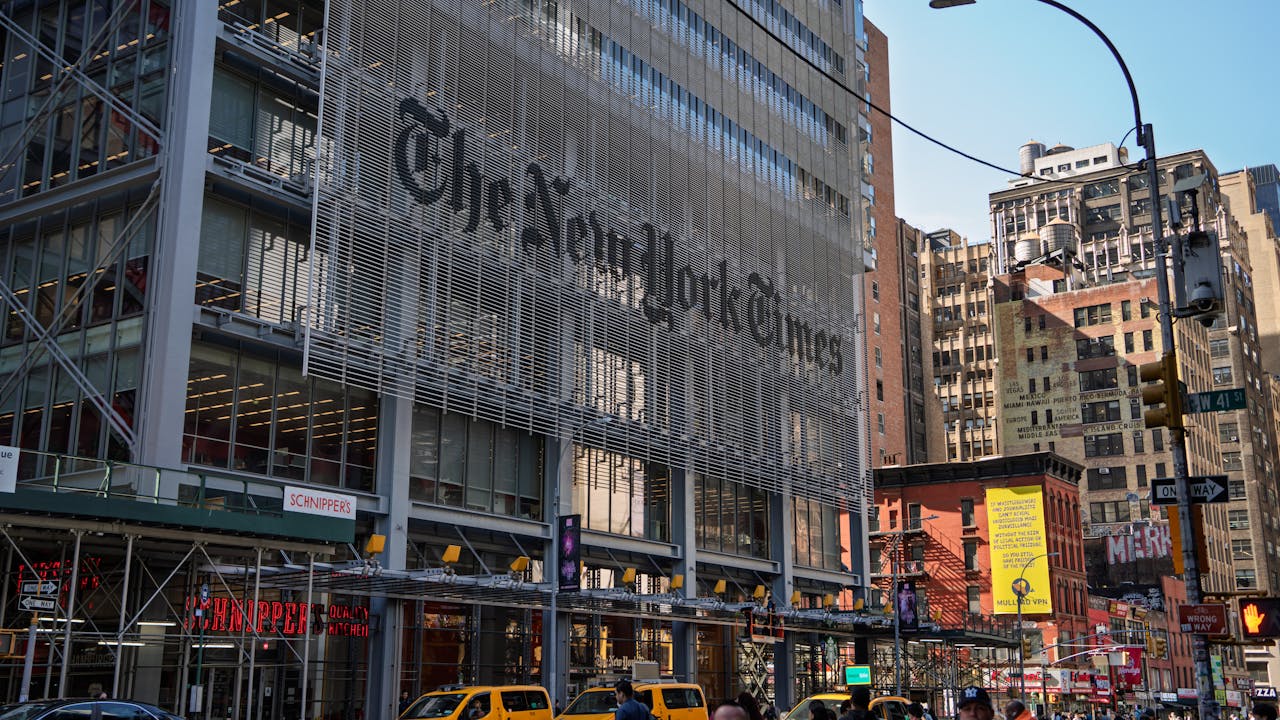 The iconic New York Times building with yellow taxis in bustling Manhattan.